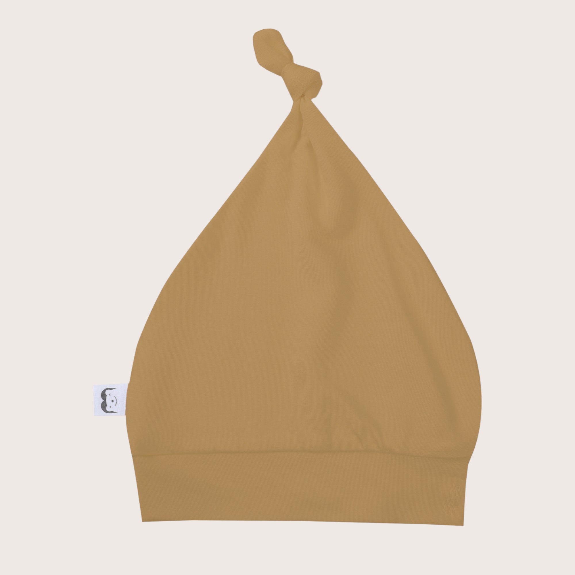 Soft, cozy bamboo knotted hat in sand beige color. Snug and stylish, perfect for newborns and infants with sensitive skin.