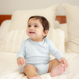 Baby wearing bamboo & organic cotton bodysuit and onesie in cloud color
