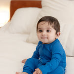 Baby wearing ribbed bamboo zipper romper in ocean blue color