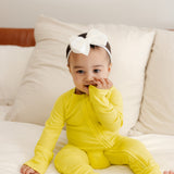 Baby wearing ribbed bamboo zipper romper in lemon yellow color