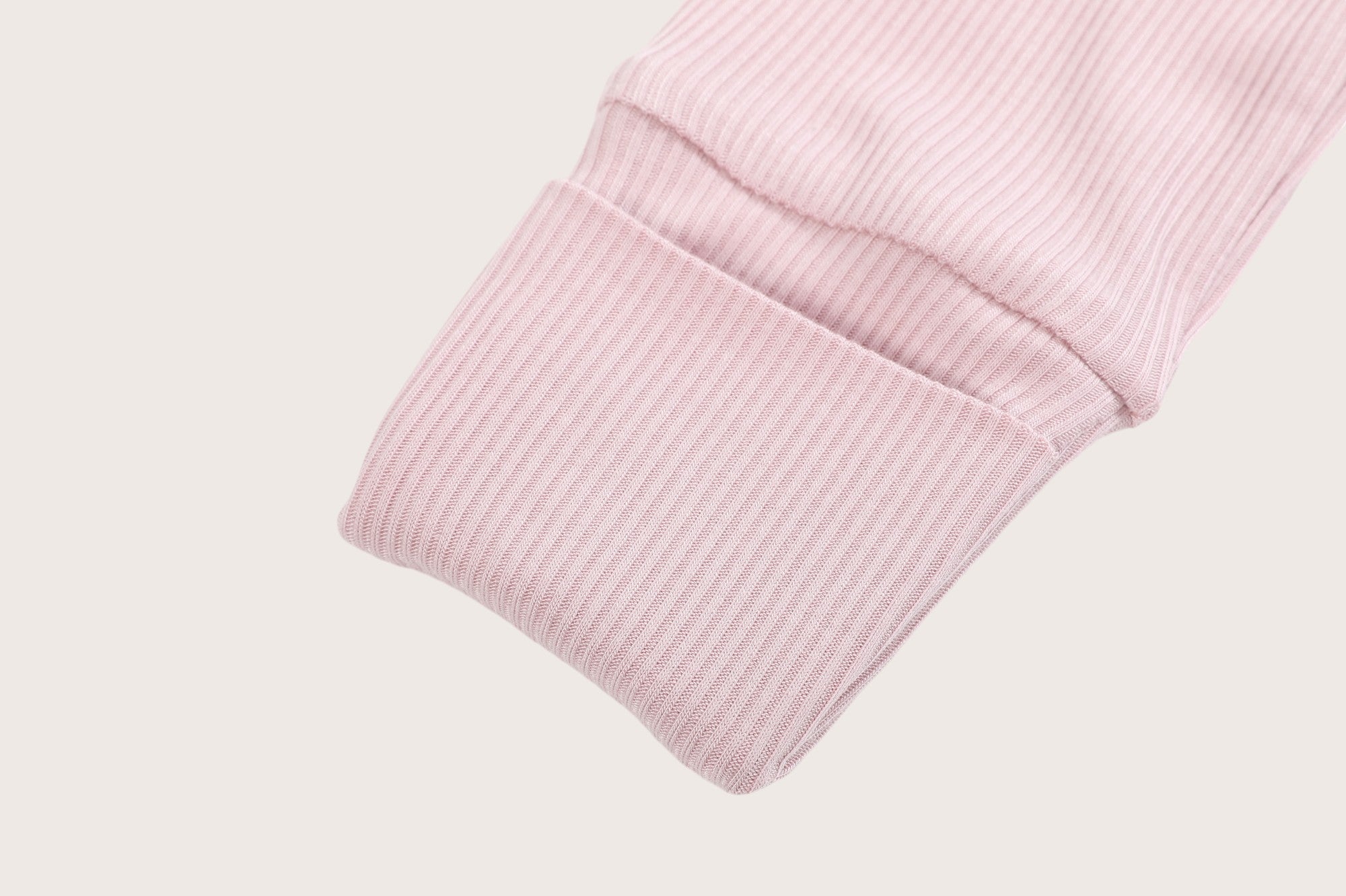 Ribbed bamboo zipper romper in blush pink color featuring fold over mittens