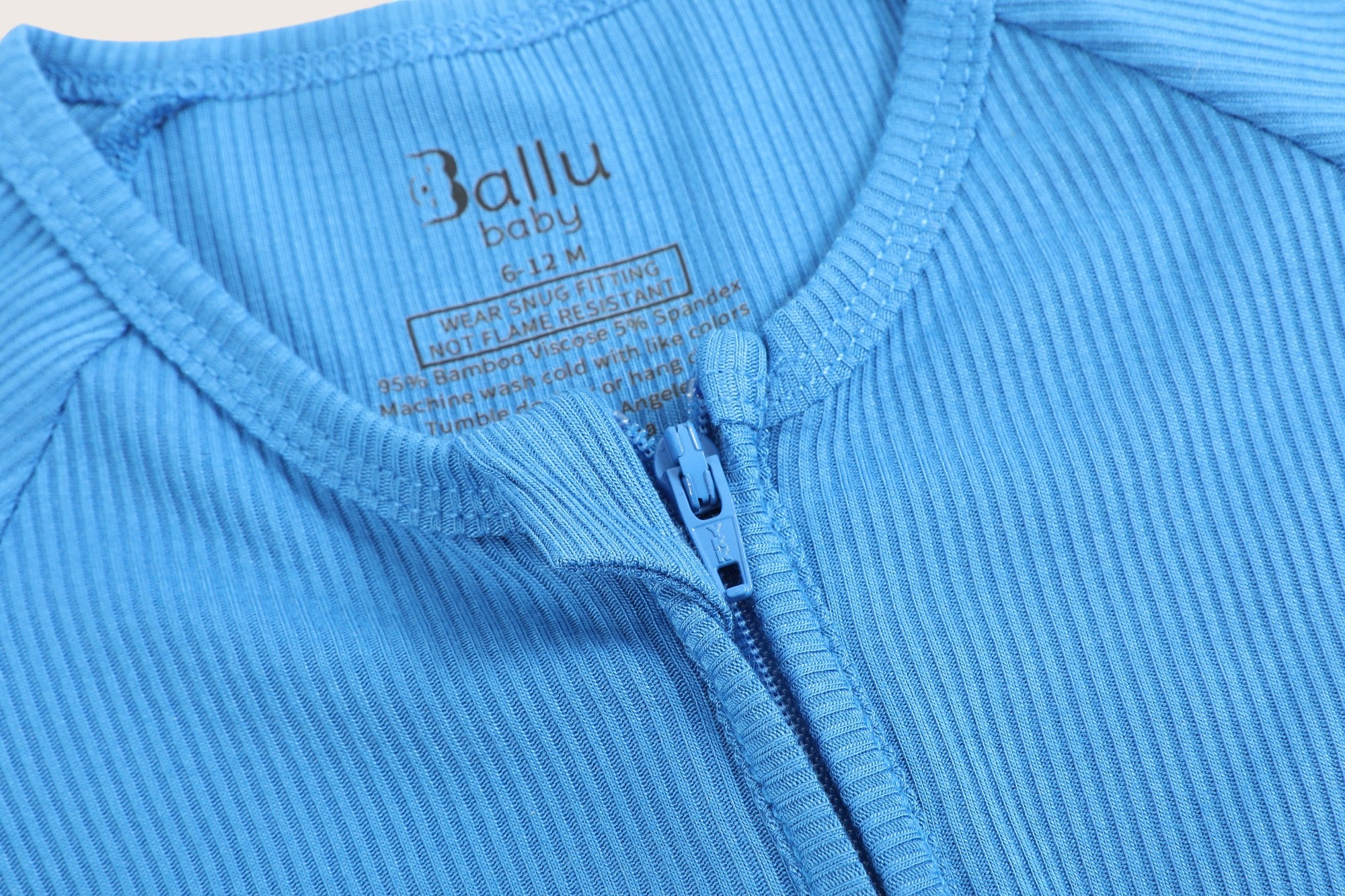 Ribbed bamboo zipper romper in ocean blue color featuring two-way zipper and fold over footies with grips
