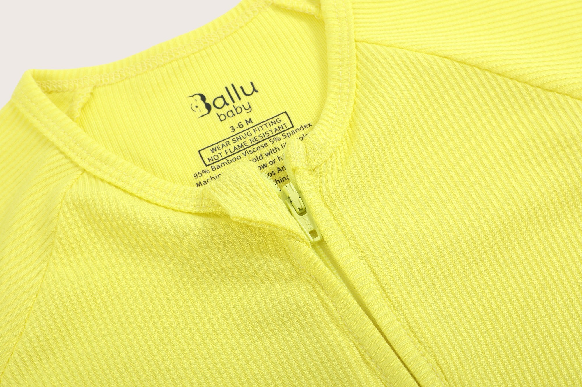 Ribbed bamboo zipper romper in lemon yellow color featuring two-way zipper