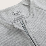 Ribbed bamboo zipper romper in stone grey color featuring two-way zipper and fold over footies with grips