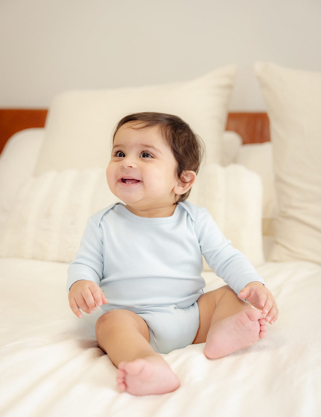 Baby wearing bamboo & organic cotton bodysuit and onesie in cloud color 