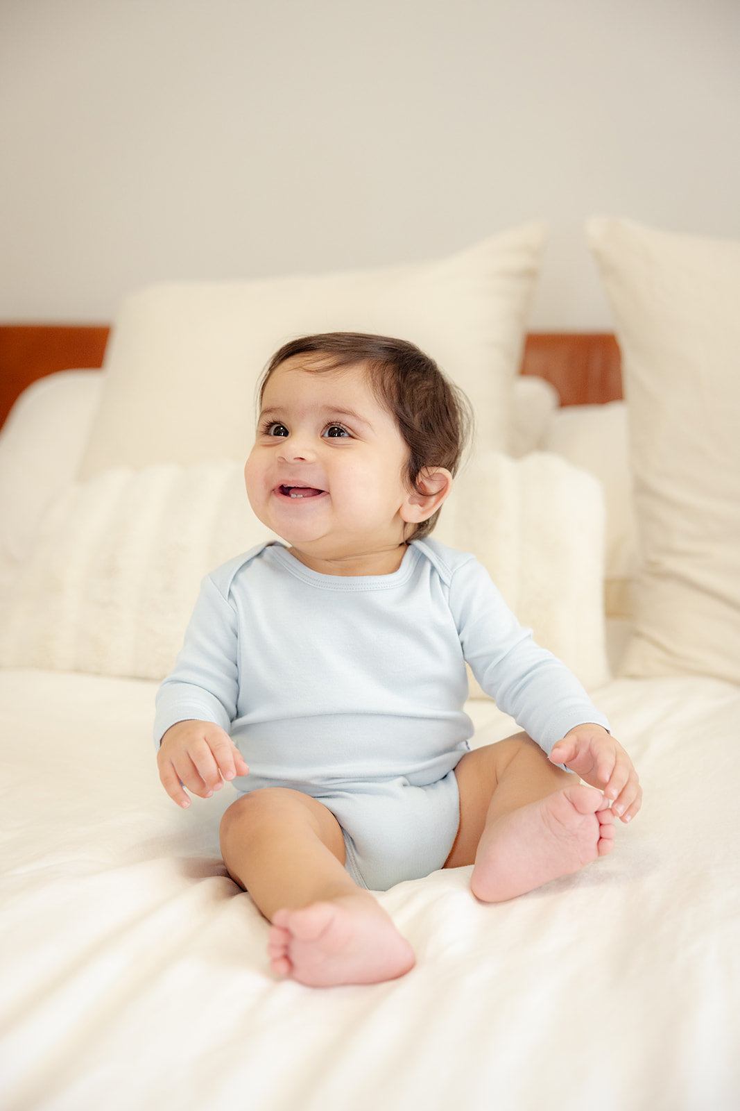 Baby wearing bamboo & organic cotton bodysuit and onesie in cloud color 