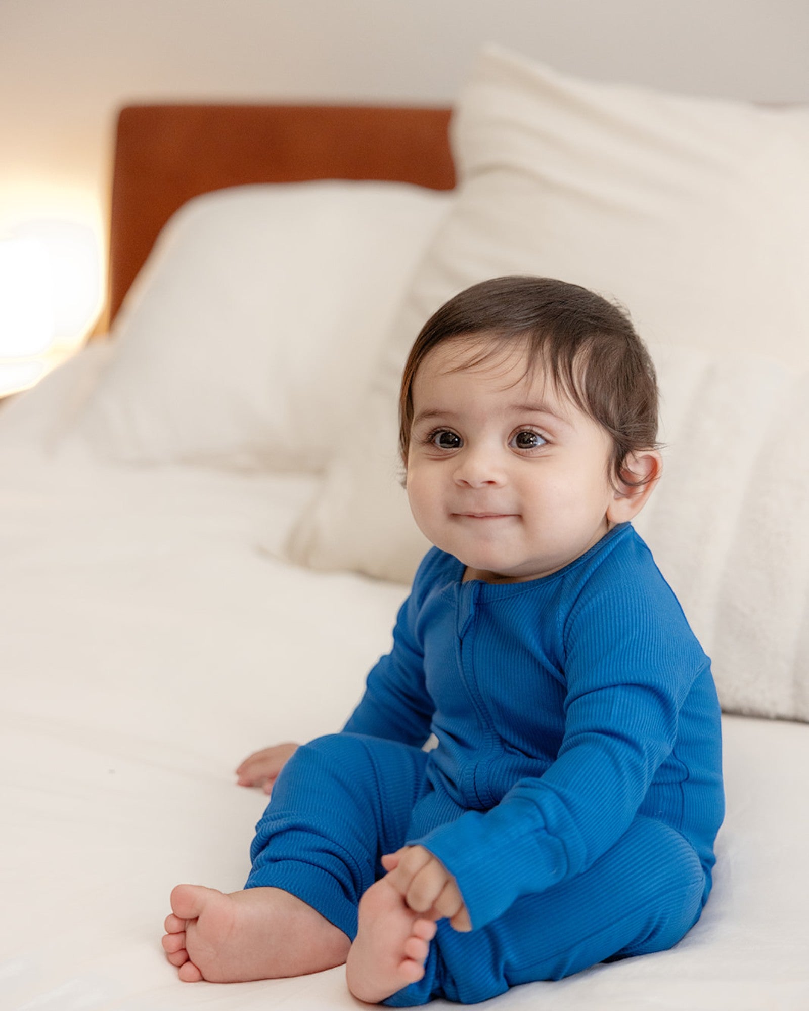 Baby wearing ribbed bamboo zipper romper in ocean blue color