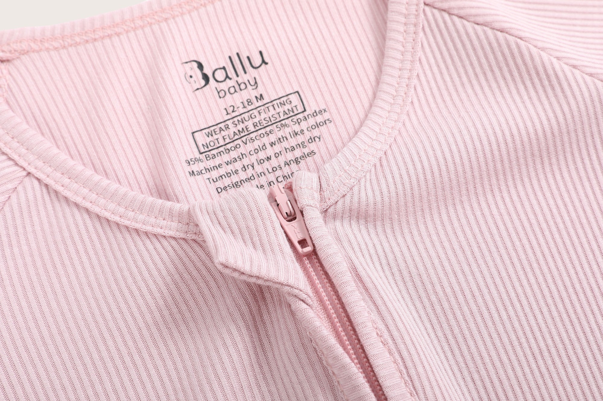 Ribbed bamboo zipper romper in blush pink color featuring two-way zipper